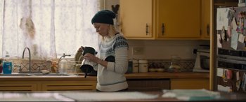 Movie still from “Brightburn” (2019), directed by David Yarovesky – A woman in a kitchen holding a tea pot; Medium shot, High angle