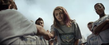 Movie still from “Brightburn” (2019), directed by David Yarovesky – A young girl is holding a man's hand while another young man watches; Medium shot, Over the shoulder angle