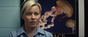 Movie still from “Brightburn” (2019), directed by David Yarovesky – A woman standing in front of a picture of a flower; Close Up shot, Over the shoulder angle