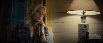 Movie still from “Brightburn” (2019), directed by David Yarovesky – A woman sitting in front of a lamp in a room; Close Up shot, Over the shoulder angle