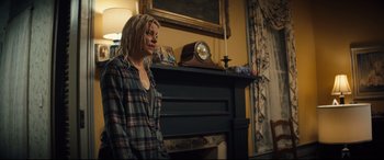 Movie still from “Brightburn” (2019), directed by David Yarovesky – A woman standing in front of a fire place; Medium shot, Over the shoulder angle