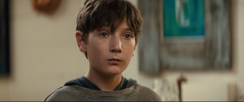 Movie still from “Brightburn” (2019), directed by David Yarovesky – A young boy is looking into the distance; Close Up shot, Over the shoulder angle