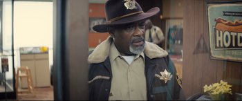 Movie still from “Brightburn” (2019), directed by David Yarovesky – A man in a brown hat and a brown jacket; Close Up shot, Over the shoulder angle