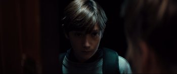 Movie still from “Brightburn” (2019), directed by David Yarovesky – A young boy is looking into the camera; Close Up shot, Over the shoulder angle