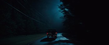 Movie still from “Brightburn” (2019), directed by David Yarovesky – A car driving down a road in the dark at night; Extreme Wide shot, Low angle