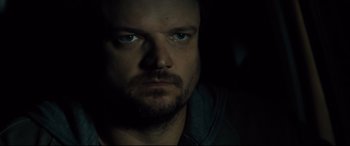 Movie still from “Brightburn” (2019), directed by David Yarovesky – A person's face in the dark; Close Up shot, Over the shoulder angle