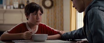 Movie still from “Brightburn” (2019), directed by David Yarovesky – A boy sitting at a table with a bowl of cereal; Close Up shot, Over the shoulder angle