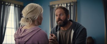 Movie still from “Brightburn” (2019), directed by David Yarovesky – A man and a woman talking in front of a mirror; Medium shot, Over the shoulder angle