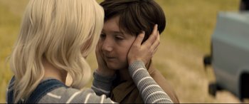 Movie still from “Brightburn” (2019), directed by David Yarovesky – A young woman holding the ear of a young boy; Close Up shot, Over the shoulder angle