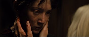 Movie still from “Brightburn” (2019), directed by David Yarovesky – A person holding their head with their hands; Close Up shot, High angle