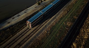 Movie still from “Source Code” (2011), directed by Duncan Jones – An aerial view of a train traveling down the tracks; Extreme Wide shot, Overhead angle