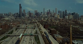 Movie still from “Source Code” (2011), directed by Duncan Jones – An aerial view of a freeway and a city skyline; Extreme Wide shot, High angle