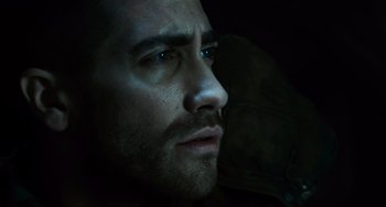Movie still from “Source Code” (2011), directed by Duncan Jones – A man's face in the dark; Close Up shot, Over the shoulder angle