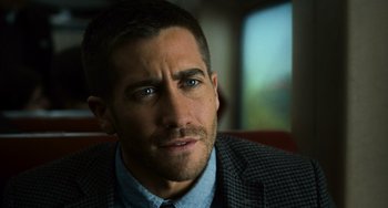 Movie still from “Source Code” (2011), directed by Duncan Jones – A person wearing a suit and tie; Close Up shot, Over the shoulder angle