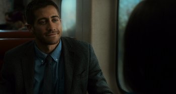 Movie still from “Source Code” (2011), directed by Duncan Jones – A person wearing a suit and tie; Close Up shot, Over the shoulder angle