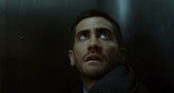 Movie still from “Source Code” (2011), directed by Duncan Jones – A person looking up at the sky; Close Up shot, Low angle