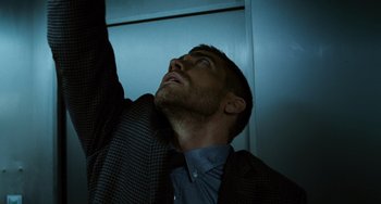 Movie still from “Source Code” (2011), directed by Duncan Jones – A person looking up at the sky; Close Up shot, Low angle