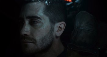 Movie still from “Source Code” (2011), directed by Duncan Jones – A man's face in the dark; Close Up shot, Over the shoulder angle