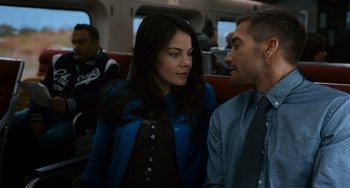 Movie still from “Source Code” (2011), directed by Duncan Jones – A man and a woman sitting next to each other on a train; Medium shot, Over the shoulder angle