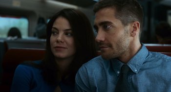 Movie still from “Source Code” (2011), directed by Duncan Jones – A man and a woman sitting next to each other on a train; Close Up shot, Over the shoulder angle