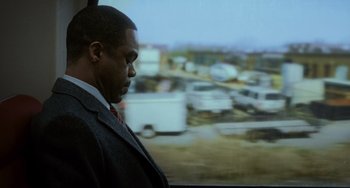 Movie still from “Source Code” (2011), directed by Duncan Jones – A man standing in front of a train window; Medium shot, Over the shoulder angle
