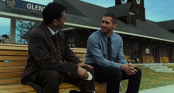 Movie still from “Source Code” (2011), directed by Duncan Jones – Two men are sitting on a bench outside; Medium shot, Over the shoulder angle