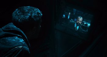 Movie still from “Source Code” (2011), directed by Duncan Jones – A man looking at a man in a suit in a mirror; Close Up shot, High angle