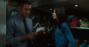 Movie still from “Source Code” (2011), directed by Duncan Jones – A man and a woman standing next to each other in front of bicycles; Medium shot, Over the shoulder angle