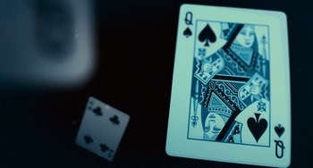 Movie still from “Source Code” (2011), directed by Duncan Jones – Playing cards and a deck of cards on a table; Extreme Close Up shot, Overhead angle