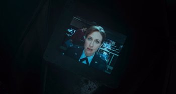 Movie still from “Source Code” (2011), directed by Duncan Jones – A picture of a woman in a uniform is projected on a wall; Close Up shot, Overhead angle