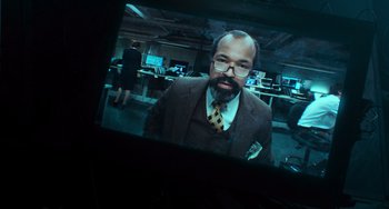 Movie still from “Source Code” (2011), directed by Duncan Jones – A man in a suit and tie in an office setting; Close Up shot, Over the shoulder angle