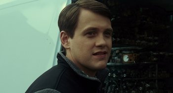 Movie still from “Source Code” (2011), directed by Duncan Jones – A person wearing a black jacket; Close Up shot, Low angle