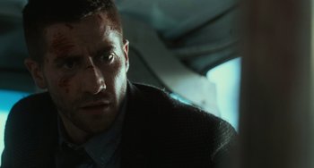 Movie still from “Source Code” (2011), directed by Duncan Jones – A person wearing a suit and tie; Close Up shot, Low angle