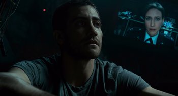 Movie still from “Source Code” (2011), directed by Duncan Jones – A person in a dark room; Close Up shot, Low angle