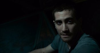 Movie still from “Source Code” (2011), directed by Duncan Jones – A person wearing a blue t - shirt; Close Up shot, High angle