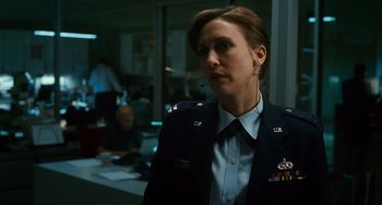 Movie still from “Source Code” (2011), directed by Duncan Jones – A woman in a military uniform is standing in front of a group of people; Close Up shot, Low angle