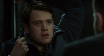 Movie still from “Source Code” (2011), directed by Duncan Jones – A person wearing a jacket; Close Up shot, High angle