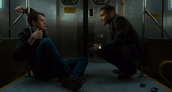 Movie still from “Source Code” (2011), directed by Duncan Jones – Two men sitting on the floor in front of a door; Medium shot, Low angle