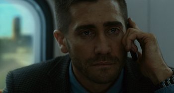 Movie still from “Source Code” (2011), directed by Duncan Jones – A person with a hand on his head; Close Up shot, Over the shoulder angle