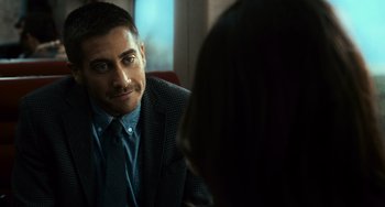 Movie still from “Source Code” (2011), directed by Duncan Jones – A person wearing a suit and tie; Close Up shot, Over the shoulder angle