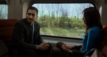 Movie still from “Source Code” (2011), directed by Duncan Jones – A man and a woman sitting in a car; Medium shot, Over the shoulder angle