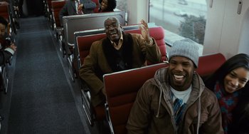 Movie still from “Source Code” (2011), directed by Duncan Jones – A group of people sitting on a bus together; Medium shot, Over the shoulder angle