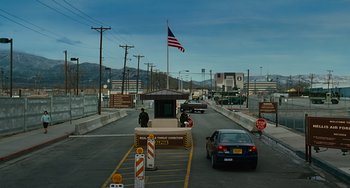 Movie still from “Source Code” (2011), directed by Duncan Jones – An entrance to the united states at an entrance to the border; Extreme Wide shot, Over the shoulder angle
