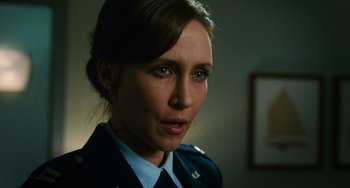 Movie still from “Source Code” (2011), directed by Duncan Jones – A person wearing a uniform; Close Up shot, Over the shoulder angle