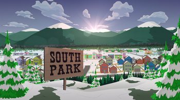 Movie still from “South Park: Joining the Panderverse” (2023), directed by Trey Parker – A sign in front of a snowy mountain range with buildings; Extreme Wide shot, Overhead angle