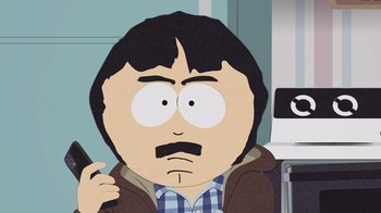 Movie still from “South Park: Joining the Panderverse” (2023), directed by Trey Parker – A man with a mustache is holding a cell phone; Medium shot, Low angle