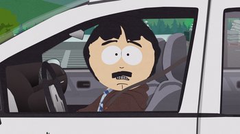 Movie still from “South Park: Joining the Panderverse” (2023), directed by Trey Parker – A man in a brown jacket sitting in the drivers seat of a white car; Medium shot, Over the shoulder angle