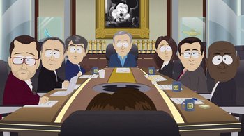 Movie still from “South Park: Joining the Panderverse” (2023), directed by Trey Parker – A group of people sitting at a table in a room; Wide shot, Over the shoulder angle