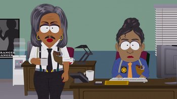 Movie still from “South Park: Joining the Panderverse” (2023), directed by Trey Parker – A woman sitting at a computer desk next to an older woman; Medium shot, Low angle