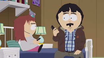 Movie still from “South Park: Joining the Panderverse” (2023), directed by Trey Parker – A man holding a cell phone while standing next to a woman; Medium shot, Over the shoulder angle